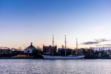 Fototapeta na wymiar An old white sailing ship in Stockholm during a colorful sunrise - 2