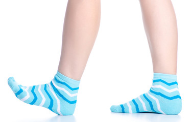 Female legs with blue socks fashion on background isolation