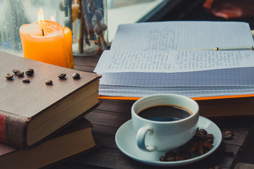  books coffee candles on the table