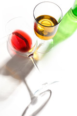 Glass glasses with drinks of different colors on a white background. Top view. The concept of an alcoholic cocktail.