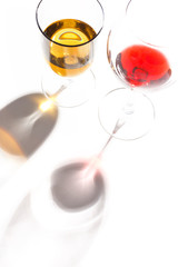 Glass glasses with drinks of different colors on a white background. Top view. The concept of an alcoholic cocktail.