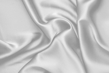 Fototapeta premium Rippled white silk fabric satin cloth waves background