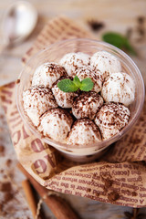 Classic tiramisu in a glass cup decorated with cocoa powder