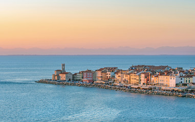View of old coastal town Piran and adriatic sea, lit by warm evening light, Slovenia