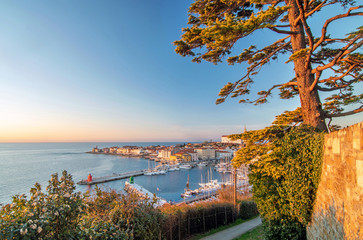 View of old coastal town Piran and adriatic sea, lit by warm evening light, Slovenia
