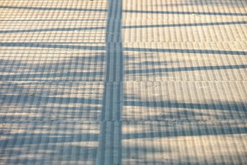 A row of sunlight shadow on the steel bridge floor for background texture 