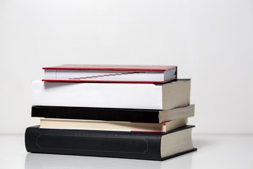 Reading books arranged on a white table. Background texture.