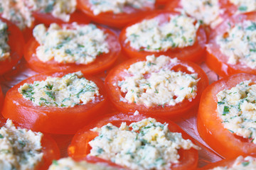 Cut tomatoes with garlic, cheese and mayonnaise. Close-up. Background. Texture.