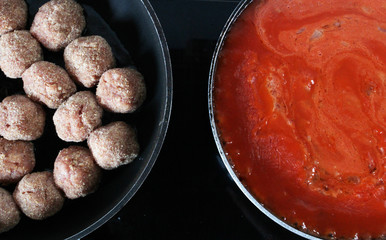 raw croquettes and gravy in pans cooking