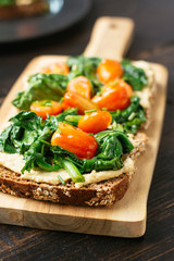 Hummus on Wholegrain Toast with Sauteed Spinach and Cherry Tomatoes