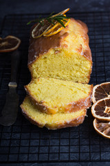Homemade orange fruit loaf cake with citrus candied fruits and nuts. Traditional treat for tea for...