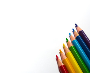 colored pencils, seven colors of the rainbow, on a white background. diagonal arrangement