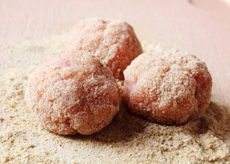 small raw meatballs breaded prepared in kitchen