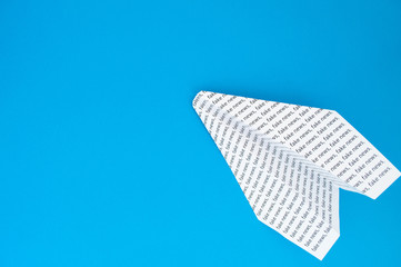 paper airplane on a blue background