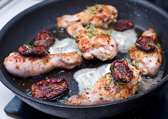 Roasted chicken legs with white cheese and tomatoes