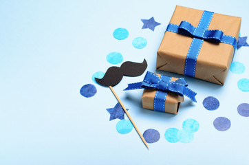 Gift Boxes and Mustache over Blue Background