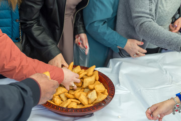 people celebrate the Kazakh holiday Nauryz. People distribute free national food, and many rush for food.