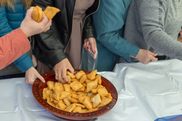 people celebrate the Kazakh holiday Nauryz. People distribute free national food, and many rush for food.