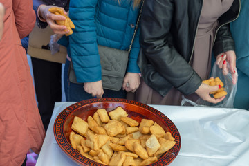 people celebrate the Kazakh holiday Nauryz. People distribute free national food, and many rush for food.