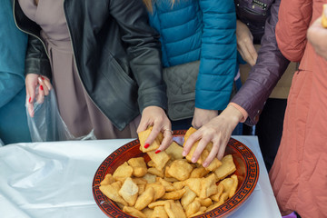 people celebrate the Kazakh holiday Nauryz. People distribute free national food, and many rush for food.