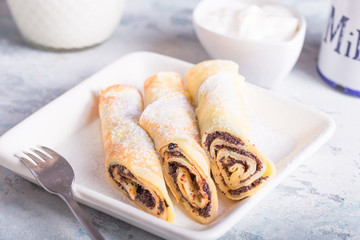 Delicious pancakes wrapped with poppy seeds