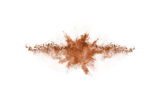 Brown color powder explosion on white background. Colored cloud. Colorful dust explode. Paint Holi.