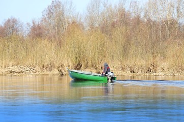 fisherman in a boat, spring