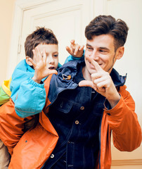 young handsome father with his son fooling around at home, lifestyle people concept close up