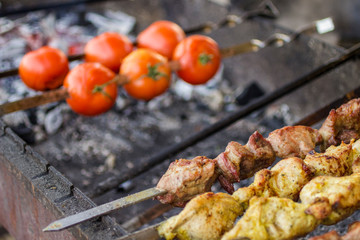 The concept of street food: grilled tomatoes and meat.