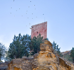 tower of a ancient castle in a small village called Villel in Teruel / Spain at the sunrise in the...