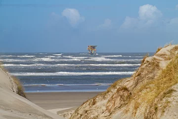 Foto auf Acrylglas Offshore production platform near the Dutch island Ameland, beach and dunes in the foreground  © Matauw