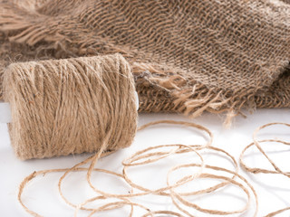 Skein of jute twine. Clew of natural rope. Roll of twine jute on sacking