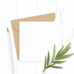 Flat lay top view elegant white composition letter kraft paper envelope pencil tag and tarragon leaf on wooden background
