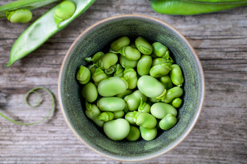 Fresh broad beans on the wooden board