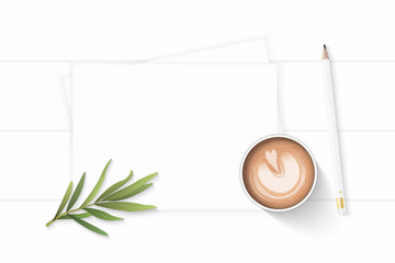 Flat lay top view elegant white Christmas composition paper pencil tarragon leaf and coffee on wooden background