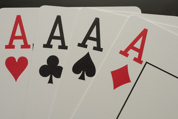 Four aces playing poker cards with tokens four of kind