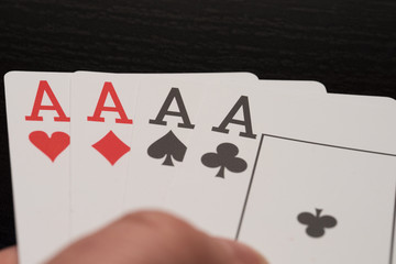 Four aces playing poker cards with tokens four of kind