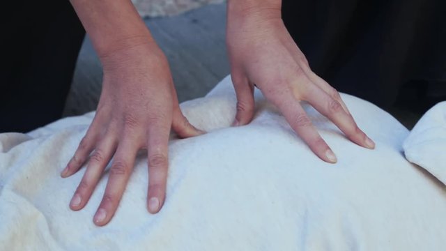 Close up young female shiatsu practicer hands doing treatment session 4k