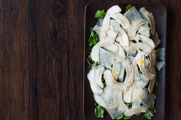 Homemade Fresh Artichoke Salad with Arugula, Rucola or Rocket Leaves on Dark Wooden Surface.