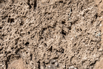 Coarse concrete plaster on a house wall as a background