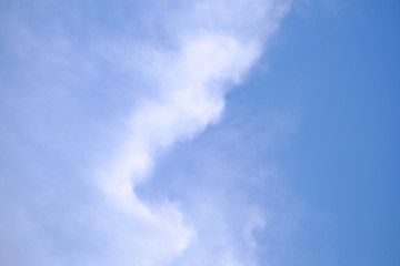 White fluffy clouds against blue sky in bright day 