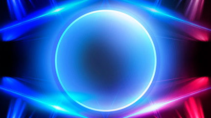 Neon circle, neon lights. Neon circle with the center of a dark empty scene with spotlights. Abstract light. Night view.