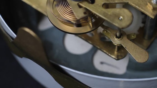Old vintage clock mechanism working, shot with soft focus. Close up of a internal clock mechanism. Vintage Watch Gears Movement Macro.