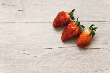 strawberry on a light wooden background. place for text. Summer background.copyspace