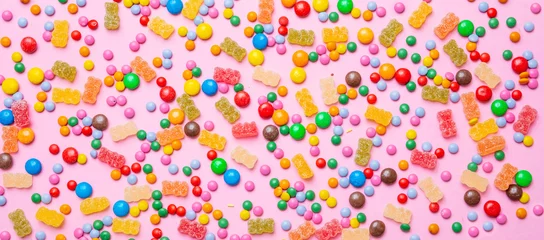 Rolgordijnen Birthday concept. Colorful sweet candies on pink background © Rawf8