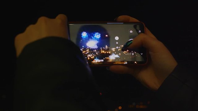 Fireworks Through Mobile Phone Holiday Celebration Background, Smartphone Firework Hand