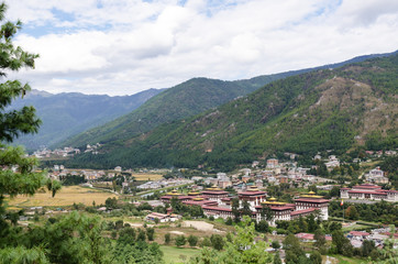 Fototapeta na wymiar Tashichho Dzong, also known as Dzong of Thimphu, in Thimphu the capital of Bhutan. Dzongs are fortress like buildings which house a monastery and governmental office rooms. View of the Thimphu Valley.