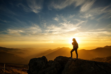 Hiker meets the sunset on the Moro rock in Sequoia national park, California, USA.