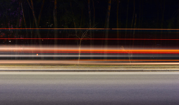 Night city traffic motion background. Traces of headlights wallpaper.