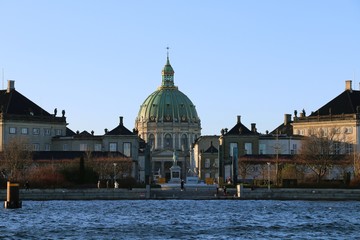 Copenhagen, Denmark. The palace of Amalienborg and the dome of the Frederik's Church popularly known as The Marble Church, seen from the see.